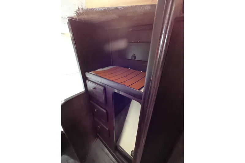 Slide: The Image of Interior cabin of a 1980 Morgan 382 sailboat with wooden storage and bunk. - 10
