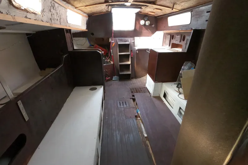 Slide: The Image of Interior of a 1980 Morgan 382 sailboat, featuring wooden furnishings and compact layout. - 14