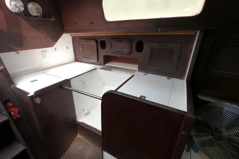 Slide: The Image of 1980 Morgan 382 yacht interior with wooden cabinetry and white countertops. - 16