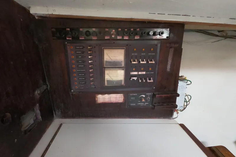 Slide: The Image of Electrical control panel inside a 1980 Morgan 382 sailboat, featuring switches and meters. - 18