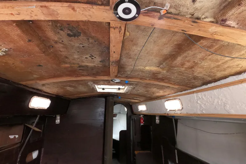 Slide: The Image of Interior of a 1980 Morgan 382 sailboat showing wooden ceiling and cabin details. - 19