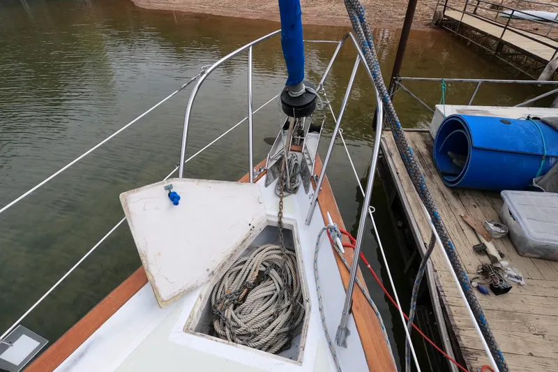 Slide: The Image of 1980 Morgan 382 sailboat bow with ropes and dockside view. - 3