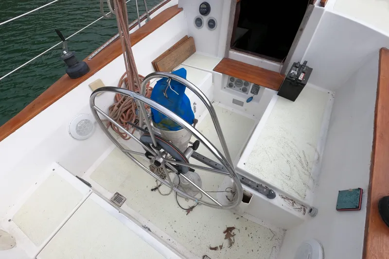 Slide: The Image of Cockpit of a 1980 Morgan 382 sailboat with steering wheel and nautical equipment. - 7