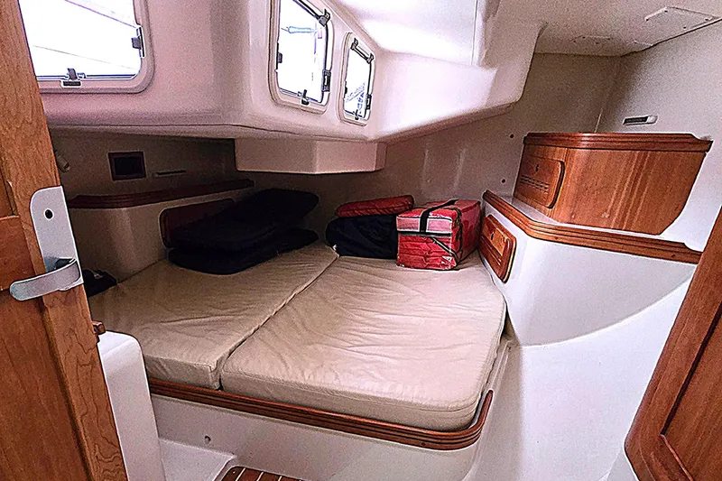 Slide: The Image of Cozy cabin interior of 2004 C&C 121 sailboat with cushioned seating and wooden accents. - 5