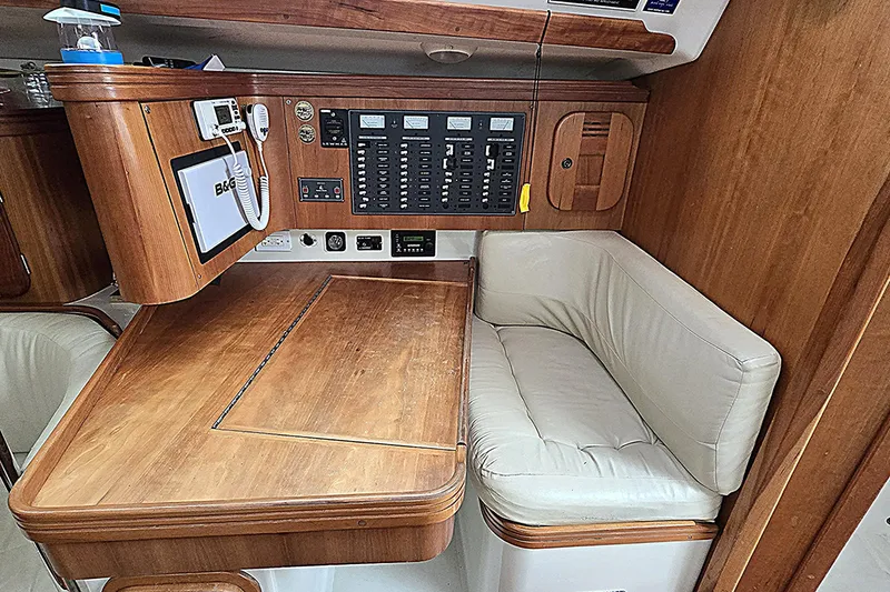 Slide: The Image of Wooden navigation station with control panel and cushioned seating in a 2004 C&C 121 yacht. - 8