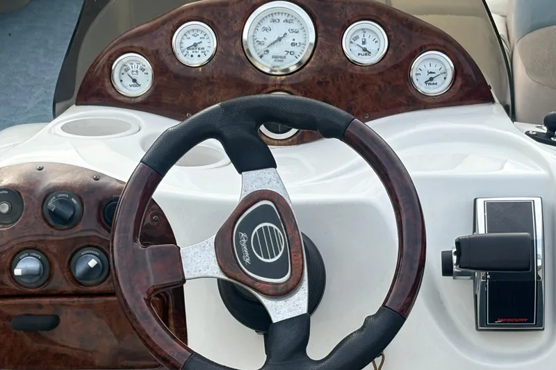 Slide: The Image of Steering console of 2004 Sun Tracker Party Barge 22 Regency Edition with gauges and controls. - 12