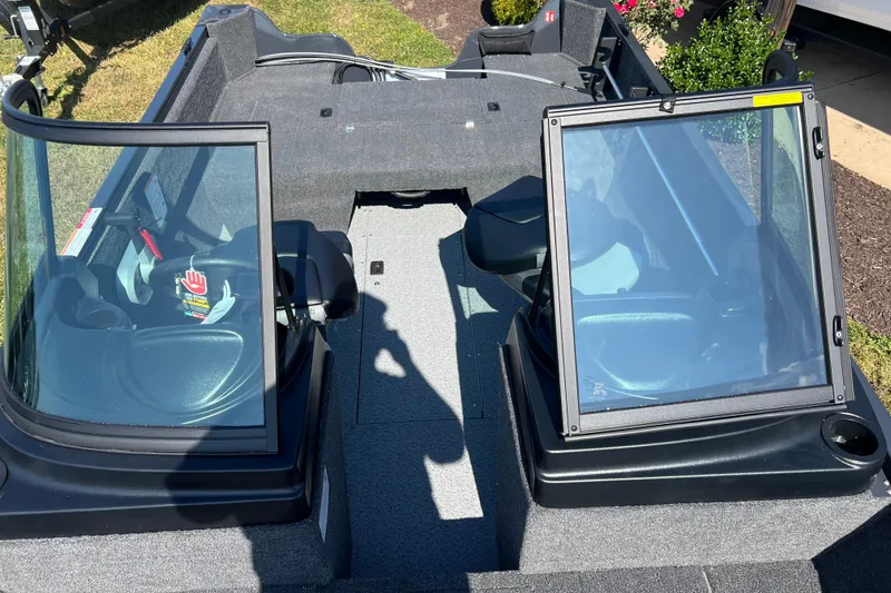 Slide: The Image of 2026 Crestliner 1650 Kodiak boat interior with dual windshields and seating. - 11