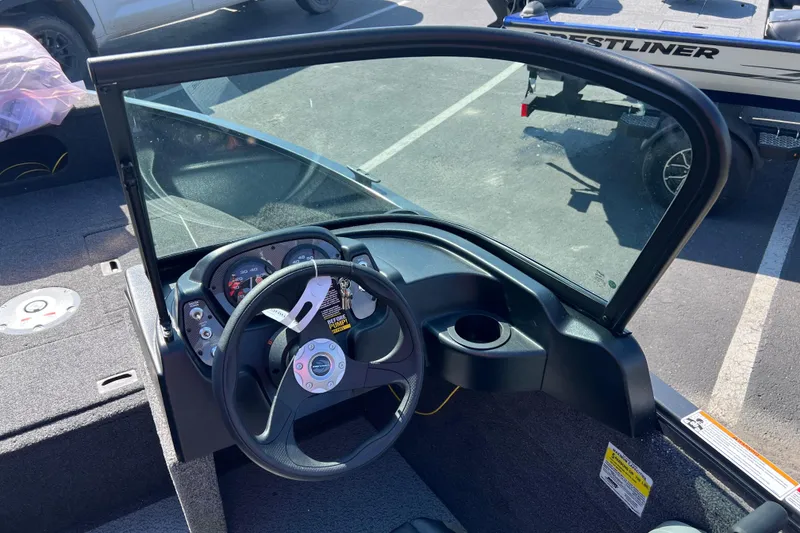 Slide: The Image of 2026 Crestliner 1650 Kodiak boat dashboard with steering wheel and gauges. - 13