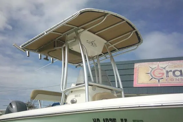 Slide: The Image of 2017 Key West 203 FS boat with T-top against a cloudy sky background. - 1