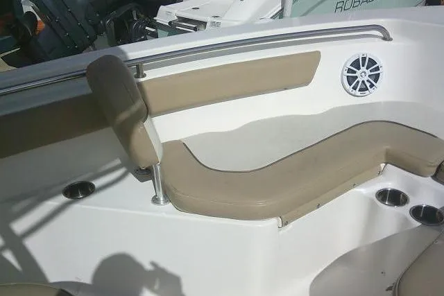 Slide: The Image of 2017 Key West 203 FS boat interior with beige seating and cup holders. - 23