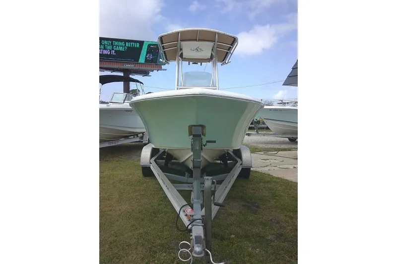 Slide: The Image of 2017 Key West 203 FS boat on trailer, parked outdoors under a cloudy sky. - 3
