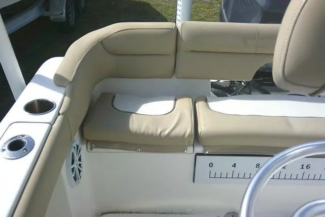 Slide: The Image of 2017 Key West 203 FS boat interior with beige seating and cup holders. - 37