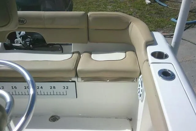 Slide: The Image of 2017 Key West 203 FS boat interior with beige seating and cup holders. - 38