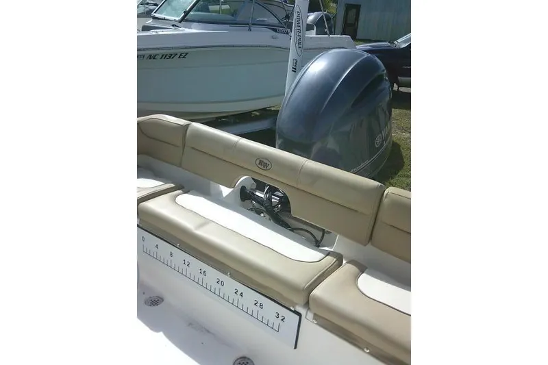 Slide: The Image of 2017 Key West 203 FS boat interior with beige seating and visible outboard motor. - 39