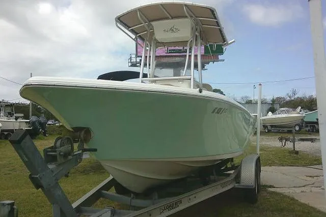 Slide: The Image of 2017 Key West 203 FS boat on trailer, parked outdoors under cloudy sky. - 4