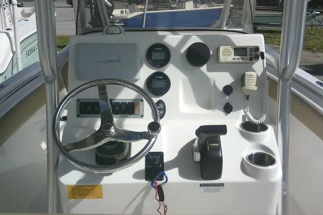 Slide: The Image of 2017 Key West 203 FS boat dashboard with steering wheel and control panel. - 40