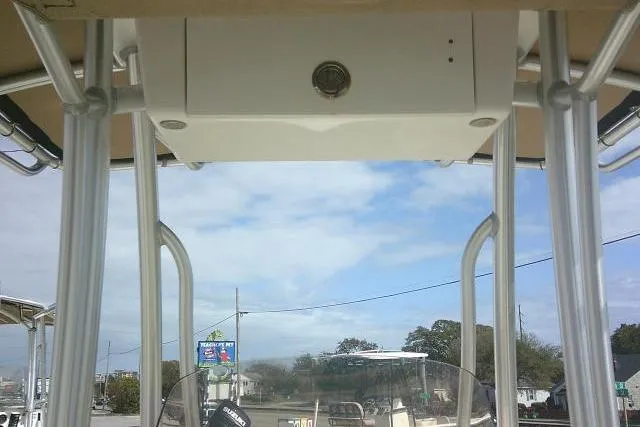 Slide: The Image of 2017 Key West 203 FS boat console with T-top under a partly cloudy sky. - 41