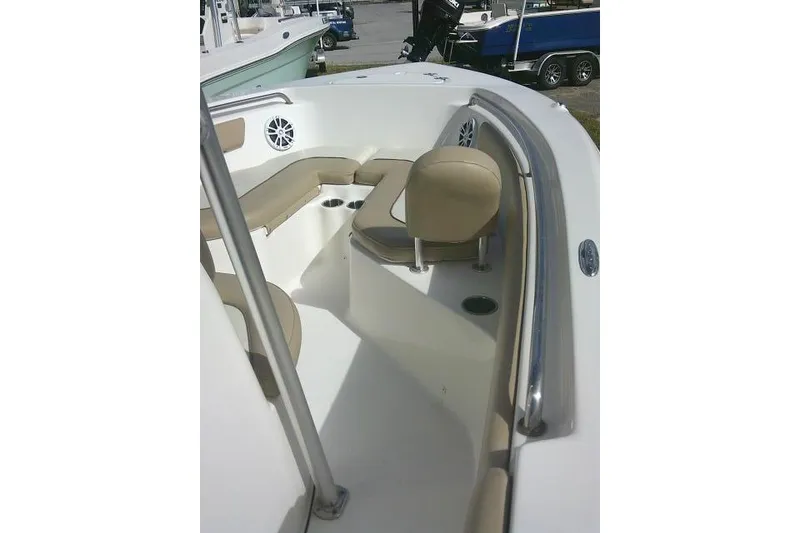 Slide: The Image of 2017 Key West 203 FS boat interior with beige seating and cup holders. - 45