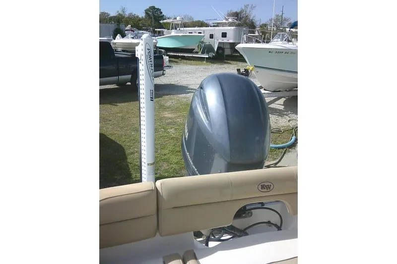 Slide: The Image of 2017 Key West 203 FS boat with outboard motor in a marina setting. - 46
