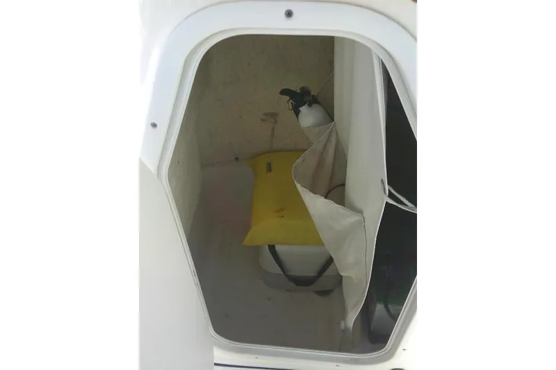 Slide: The Image of Interior storage compartment of 2017 Key West 203 FS boat with safety equipment. - 48
