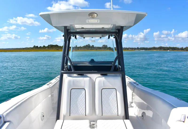Slide: The Image of 2020 Sea Fox 266 Commander boat on calm blue water under clear sky. - 13