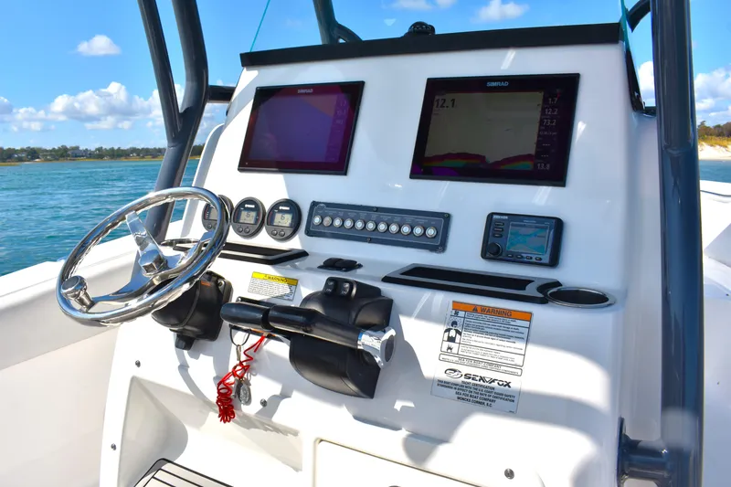 Slide: The Image of 2020 Sea Fox 266 Commander boat dashboard with steering wheel and navigation displays. - 15