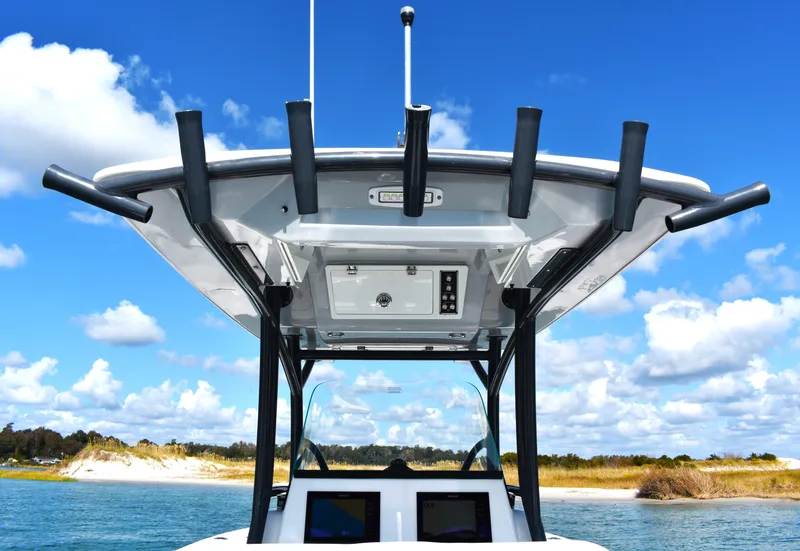 Slide: The Image of 2020 Sea Fox 266 Commander boat with T-top against blue sky and water backdrop. - 25