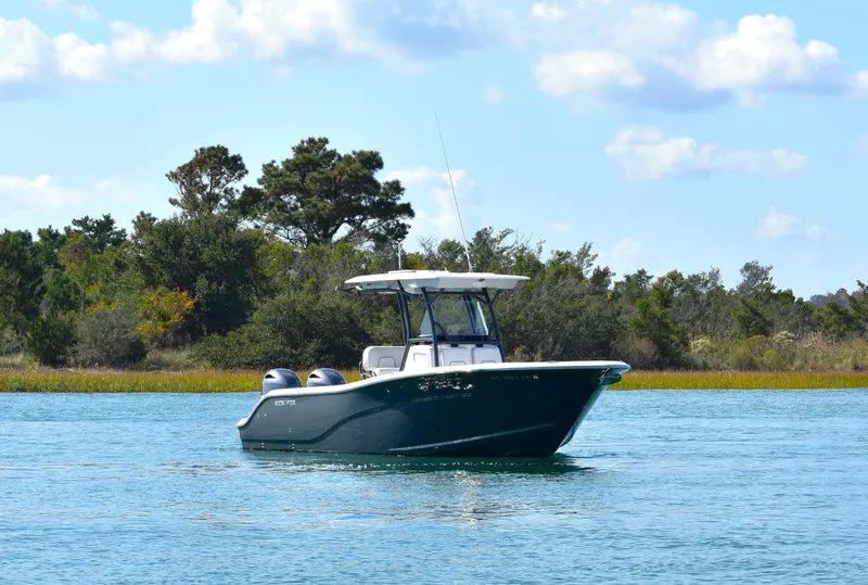 Slide: The Image of 2020 Sea Fox 266 Commander boat on calm water with scenic background. - 3