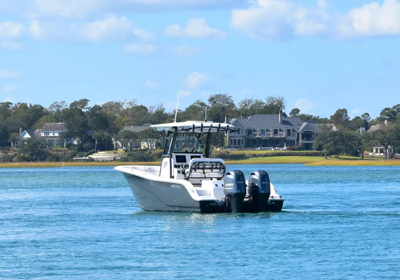 Slide: The Image of 2020 Sea Fox 266 Commander boat on calm water with scenic shoreline background. - 6