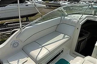 Slide: The Image of 1995 Sea Ray 250 Sundancer boat interior with white seating and sleek design. - 11