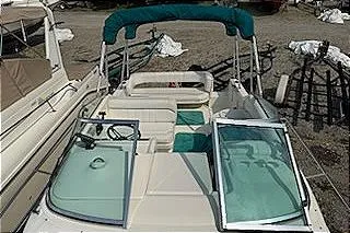 Slide: The Image of 1995 Sea Ray 250 Sundancer boat with open deck and green canopy. - 15