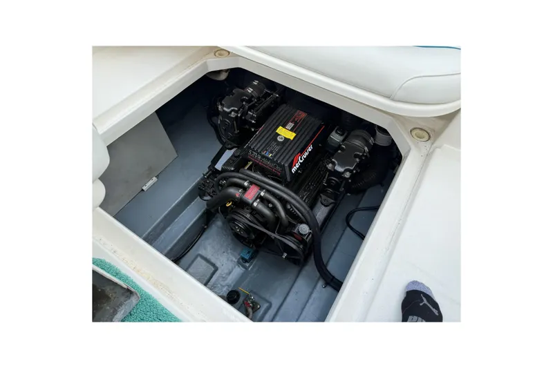 Slide: The Image of Engine compartment of a 1995 Sea Ray 250 Sundancer boat, featuring a MerCruiser engine. - 17