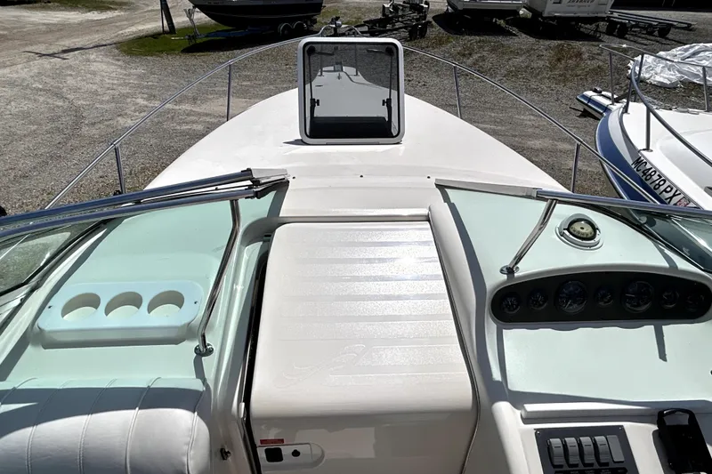 Slide: The Image of 1995 Sea Ray 250 Sundancer boat dashboard with gauges and open hatch. - 22