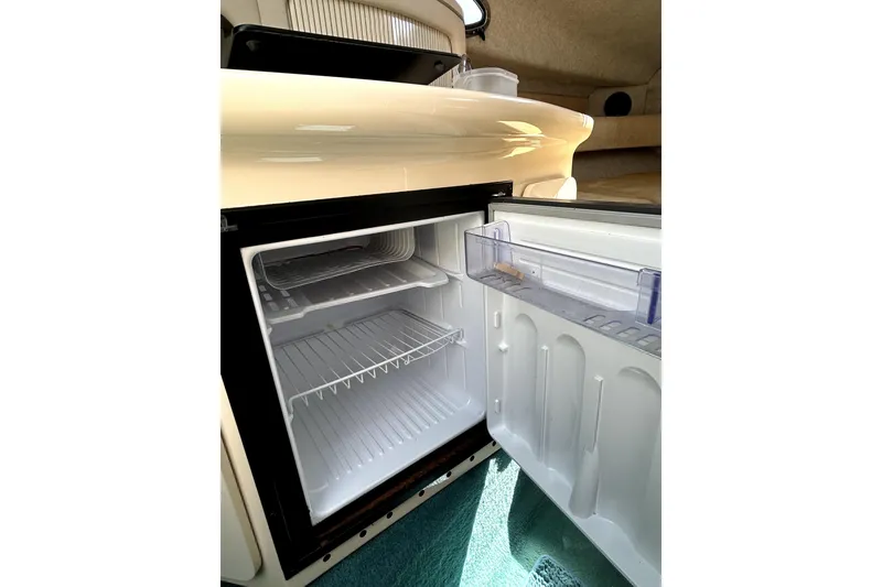Slide: The Image of Open refrigerator inside 1995 Sea Ray 250 Sundancer boat cabin. - 29