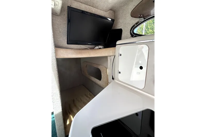 Slide: The Image of Interior cabin of 1995 Sea Ray 250 Sundancer with TV and storage compartment. - 31