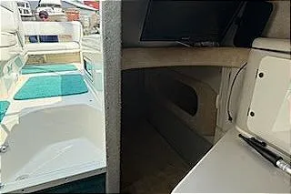 Slide: The Image of 1995 Sea Ray 250 Sundancer cabin interior with seating and storage. - 6