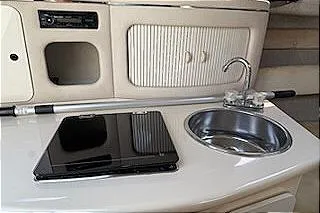 Slide: The Image of 1995 Sea Ray 250 Sundancer boat interior with sink and stove. - 7