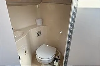 Slide: The Image of 1995 Sea Ray 250 Sundancer boat bathroom with toilet and sink. - 8