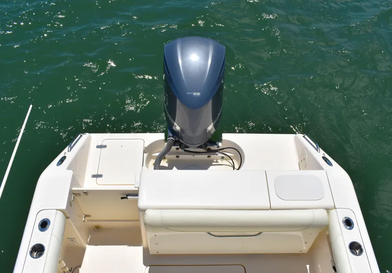 Slide: The Image of 2012 Pursuit DC 265 Dual Console boat with outboard motor on water. - 12