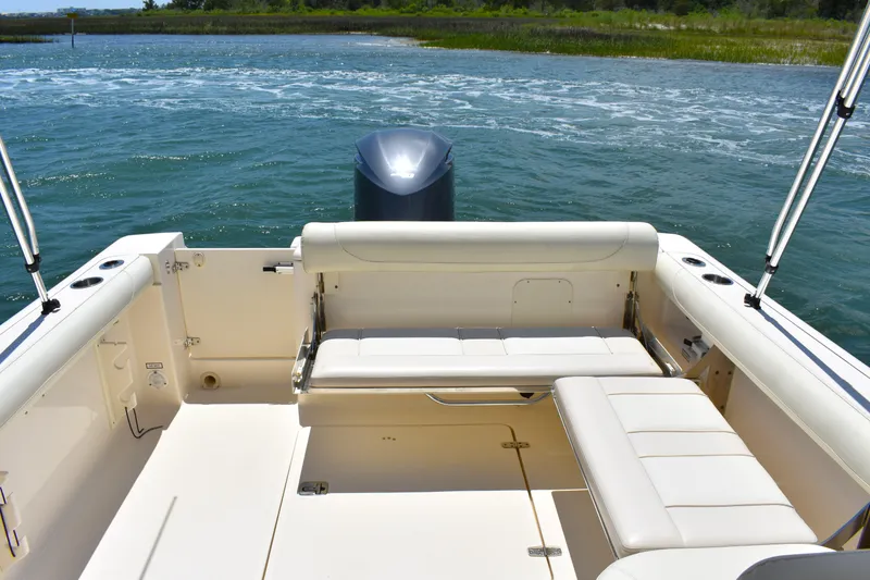Slide: The Image of 2012 Pursuit DC 265 Dual Console boat with spacious seating, on calm waters. - 13