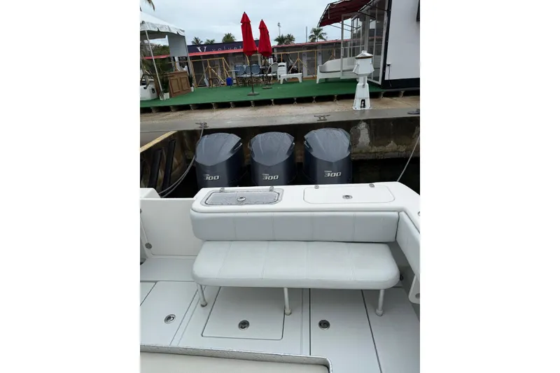 Slide: The Image of 2020 Contender 35 ST boat with triple 300 horsepower engines docked at marina. - 10