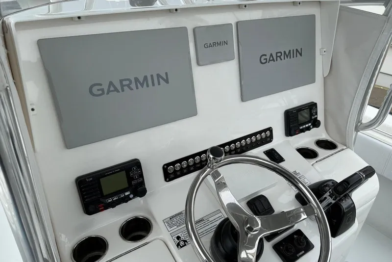 Slide: The Image of 2020 Contender 35 ST boat dashboard with Garmin navigation displays and controls. - 11