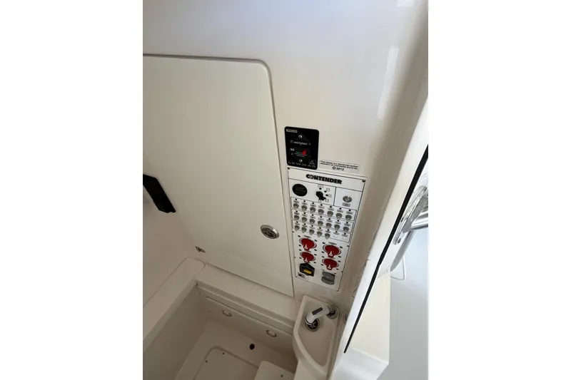 Slide: The Image of Control panel of a 2020 Contender 35 ST boat, featuring switches and gauges. - 13