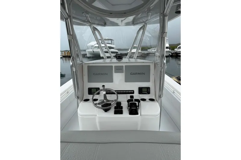 Slide: The Image of 2020 Contender 35 ST boat helm with Garmin navigation systems at a marina. - 18