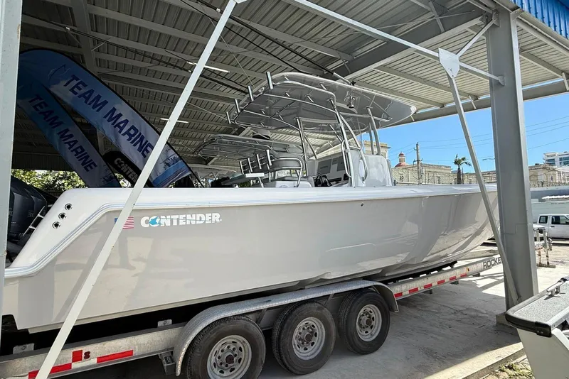 Slide: The Image of 2020 Contender 35 ST boat on trailer under shelter, Team Marine banner visible. - 5
