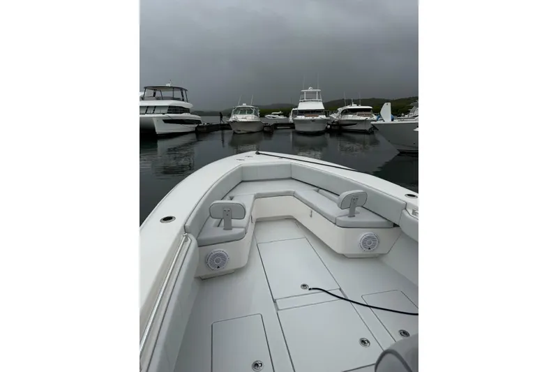 Slide: The Image of 2020 Contender 35 ST boat docked, surrounded by other vessels under cloudy skies. - 8