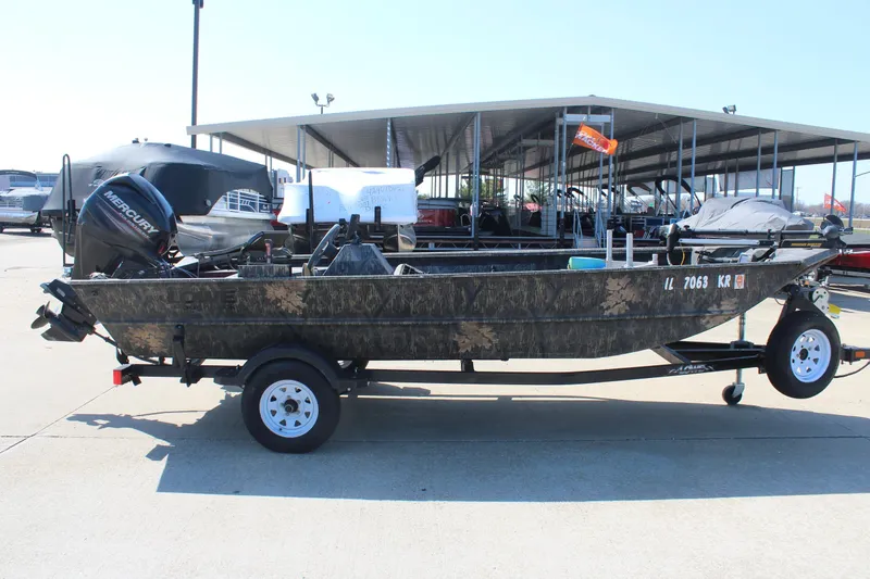 The Image of 2014 Lowe Roughneck 1756 boat with Mercury engine on trailer at marina. - 0