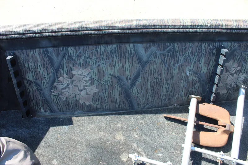 Slide: The Image of 2014 Lowe Roughneck 1756 boat interior with camouflage design and metal equipment. - 12