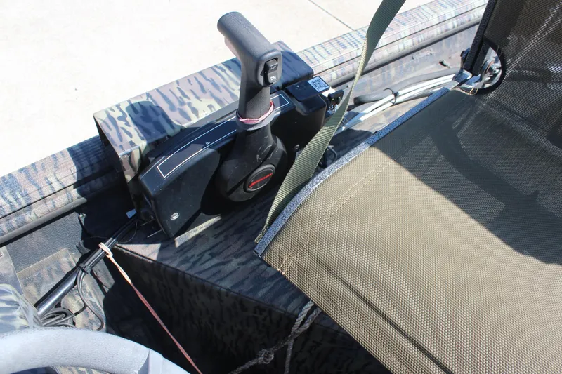 Slide: The Image of 2014 Lowe Roughneck 1756 boat interior with control lever and camouflage design. - 15