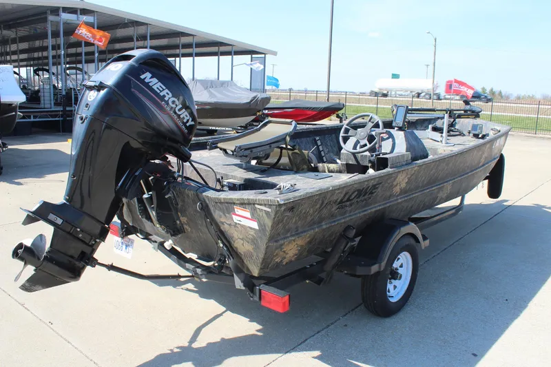 Slide: The Image of 2014 Lowe Roughneck 1756 boat with Mercury outboard motor on trailer, parked outdoors. - 7